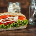 A Subway turkey sandwich loaded with fresh veggies and served on whole-grain bread, highlighting a low-calorie meal option.
